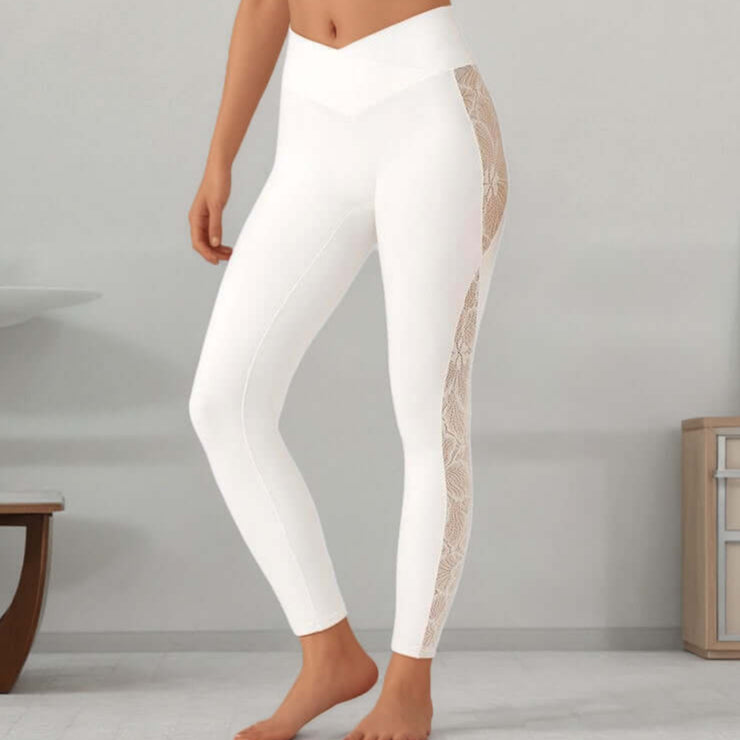 White slim fit leggings with lace side panels, showcasing a high-waisted design for a stylish and comfortable look.