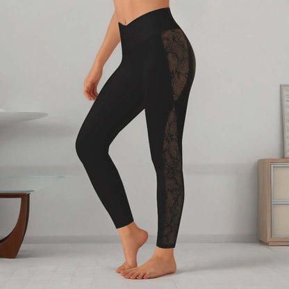 Woman wearing black slim fit leggings with lace detailing on the side, standing in a minimalist room with modern decor.
