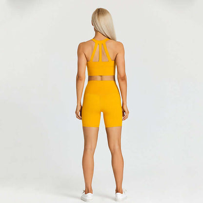 Woman in yellow sports outfit, back view, demonstrating activewear set with racerback top and high-waisted shorts suitable for outdoor sports.