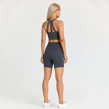 Woman wearing a stylish outdoor sport set for active lifestyles, featuring a dark-colored sports bra and shorts, perfect for exercise.