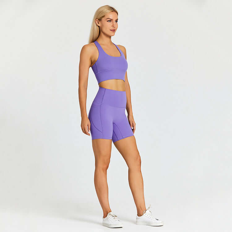 Woman wearing a purple outdoor sport set outfit, including a tank top and shorts, designed for athletic and casual wear.