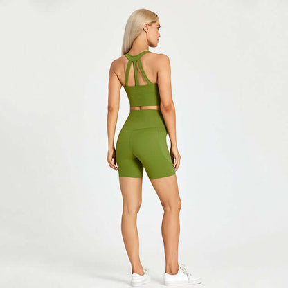 Woman wearing green athletic sports set with shorts and top, suitable for outdoor activities, showcasing fashion and fitness.
