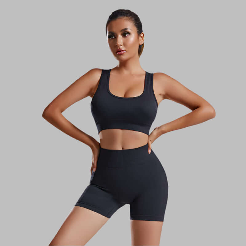 Woman wearing seamless 2pcs set, stylish nylon material, solid black color, showcasing fashion and comfort.