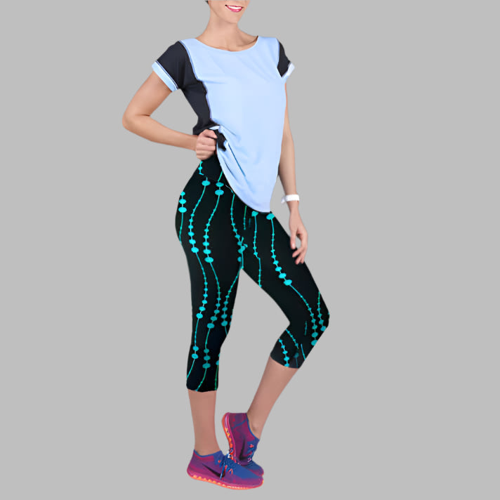 Woman wearing printed yoga leggings with a casual top and pink sneakers, showcasing the design and fit of the activewear.