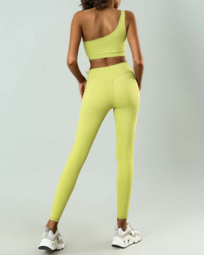 Woman wearing high elastic lime green workout set with one-shoulder top and leggings, ideal for yoga or gym, viewed from behind.