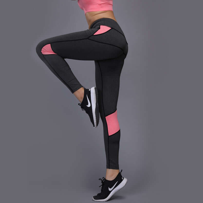 Athletic mesh panel leggings in black with pink accents, perfect for workouts, made from polyester fiber for comfort and flexibility.