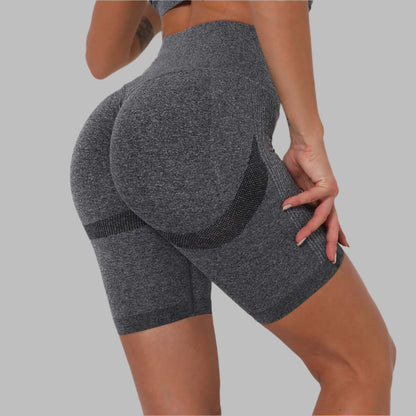 Woman wearing gray high-waisted seamless butt-lifting shorts, highlighting fitness apparel style and comfort.