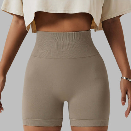 Woman wearing seamless high waist shorts in beige, showcasing comfortable fit and high hip design.