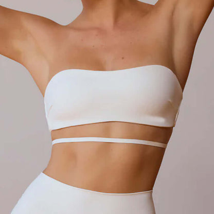 Minimalist white workout beauty set featuring strapless top and high-waisted bottoms, showcasing elegance and comfort.