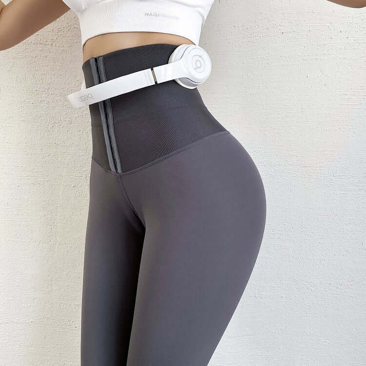 High-waisted seamless compression leggings with slimming belt for enhanced shape and support.