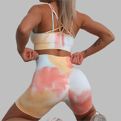 Woman modeling seamless sport set with colorful tie-dye pattern, showcasing flexible and comfortable activewear.