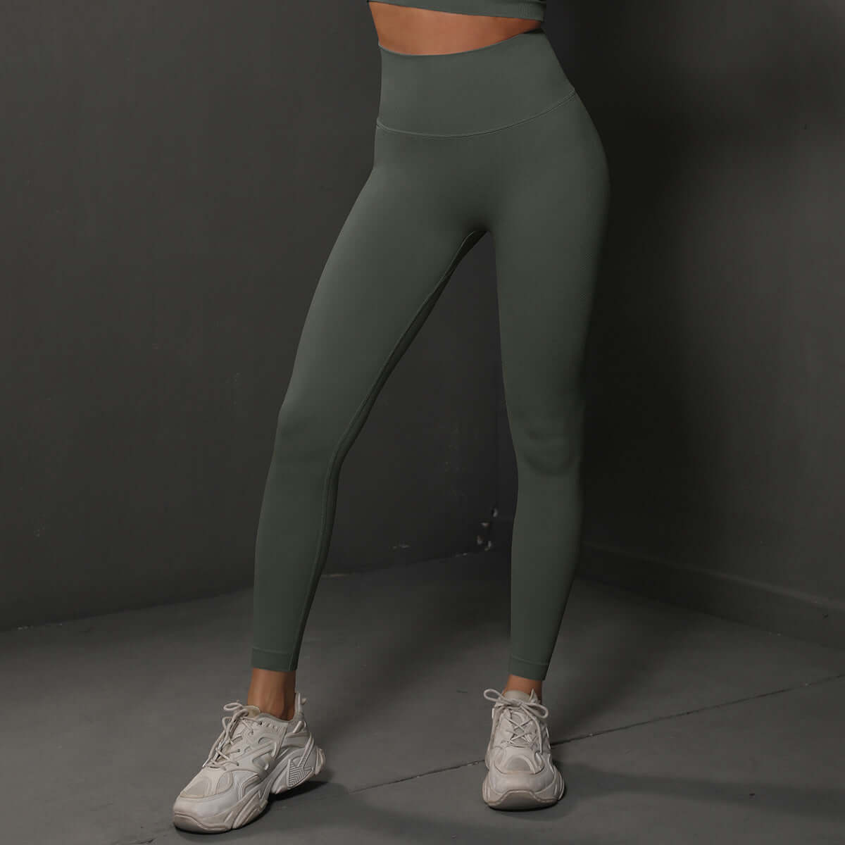 Model wearing high waist green leggings with white sneakers