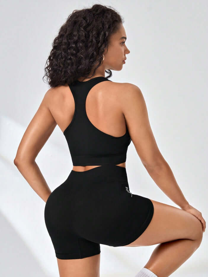 Women's seamless workout set in black, featuring a comfortable fit with stretchy fabric. Ideal for yoga and gym wear. Activewear fashion.