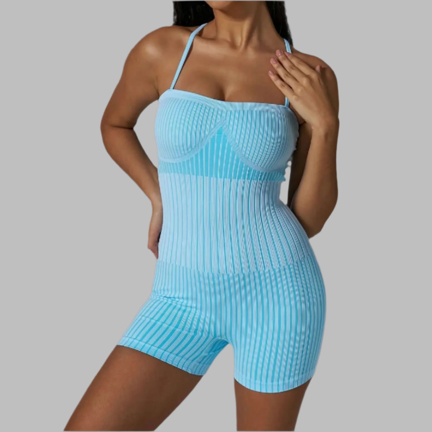 Ribbed strappy bodysuit in blue. Made from organic cotton. Offers a relaxed fit. Features breathable material for comfort.