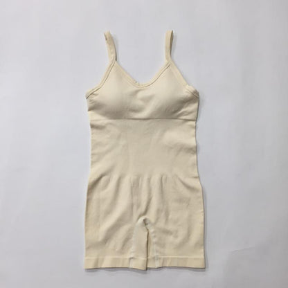 Organic cotton seamless knit yoga jumpsuit in beige. Relaxed fit and breathable material. Perfect for comfortable workouts.