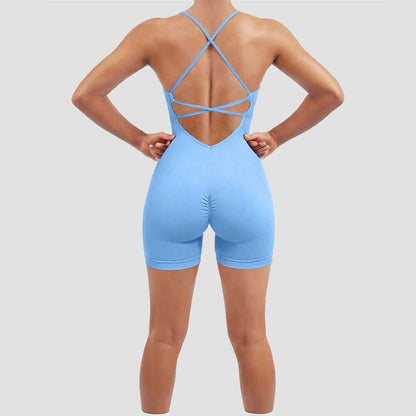 Woman wearing a blue seamless quick-dry fitness romper with organic cotton. Relaxed fit and breathable material for workouts.