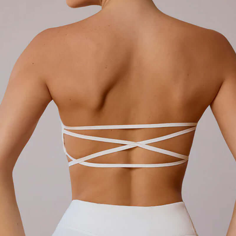 Back view of woman wearing a stylish white criss-cross sports bra, part of the Workout Beauty Set, perfect for activewear.