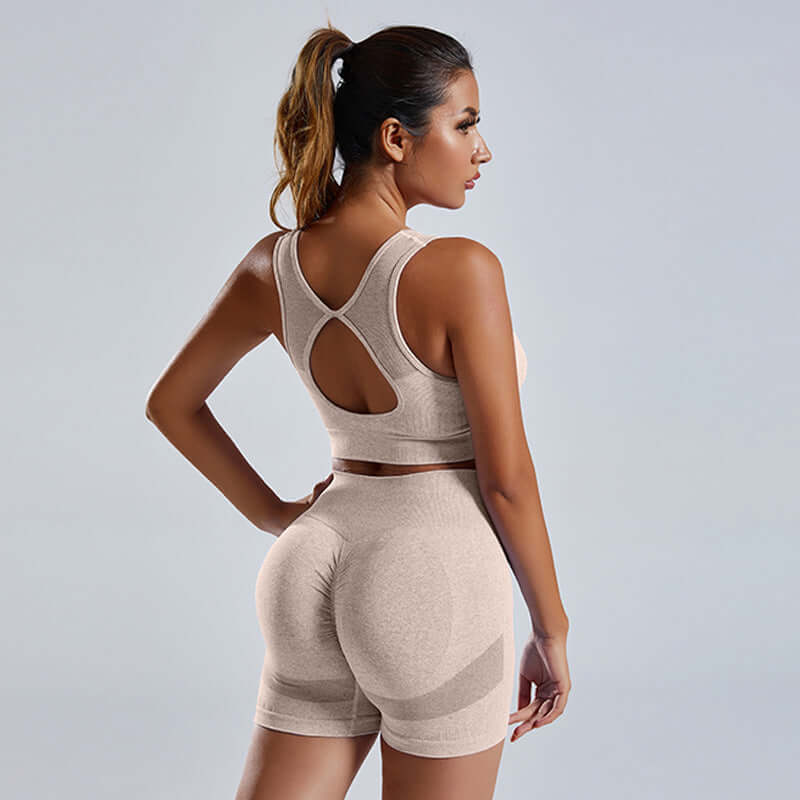 Woman wearing seamless 2-piece activewear set in beige, showcasing stylish design and comfortable fit, ideal for fashion-conscious individuals.