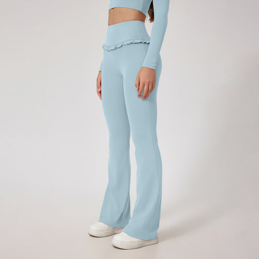 Woman wearing high waist leggings with flared bottom in light blue color, showcasing a stylish and comfortable fitness outfit.