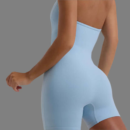 Sleek body sculpting jumpsuit in light blue showcasing fit and style against a neutral background