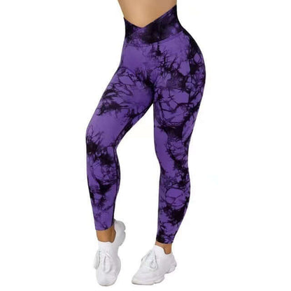 Purple tie dye leggings featuring a high waist fit, paired with white sneakers, showcasing stylish and comfortable activewear.