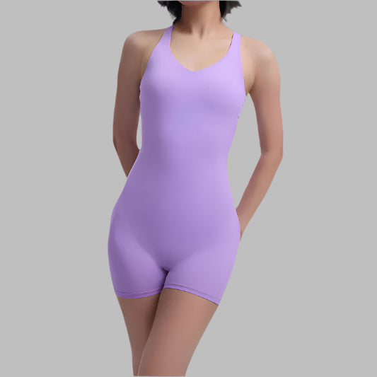 Woman wearing a purple fitness bodysuit. Organic cotton, relaxed fit, breathable material.