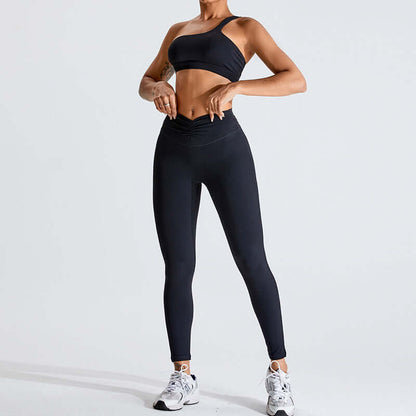 Woman modeling black fashion yoga set with sports bra and high-waisted leggings, ideal for fitness and casual wear.