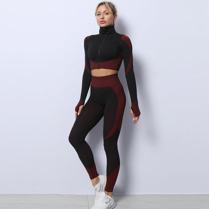 Woman wearing black and maroon seamless leggings with a matching crop top, showcasing a stylish activewear outfit.