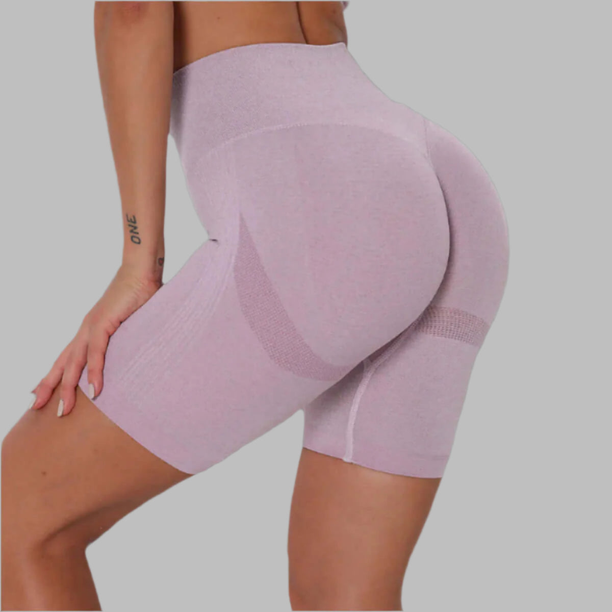 High-waisted pink athletic shorts with a seamless design, offering comfort and style for workouts and casual wear.