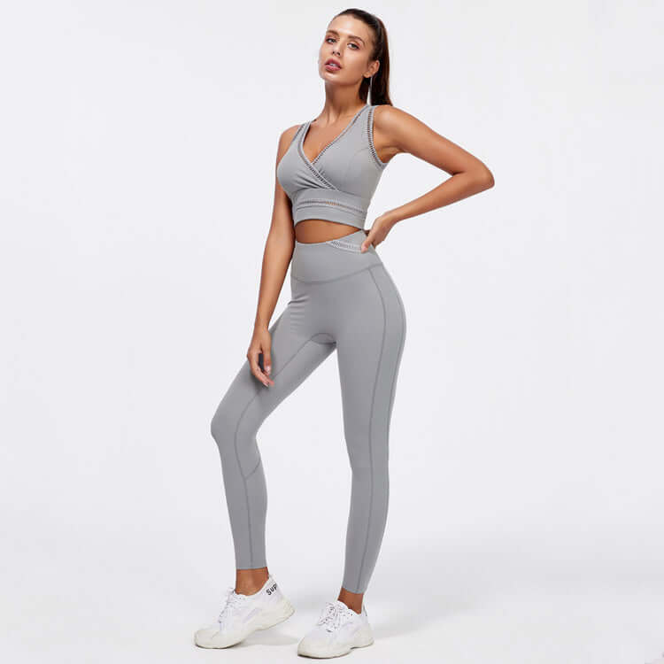 Woman wearing grey hip-lifting peach trousers yoga fitness suit, featuring sleeveless top and sculpting fit for gym and daily wear.