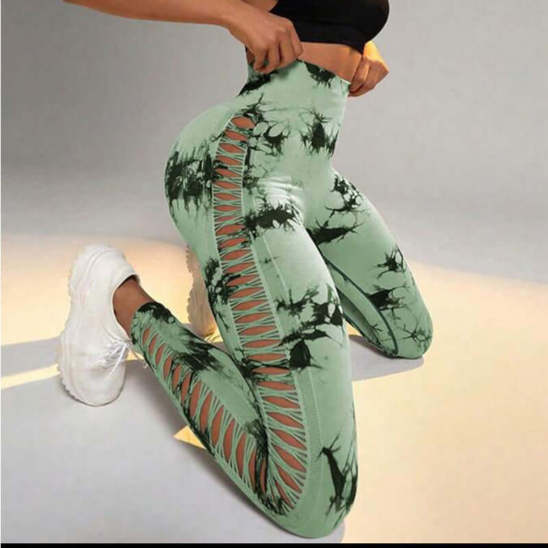 Green butt-lift gym leggings with cut-out details, perfect for workouts, showcasing a sleek and stylish design for active wear.