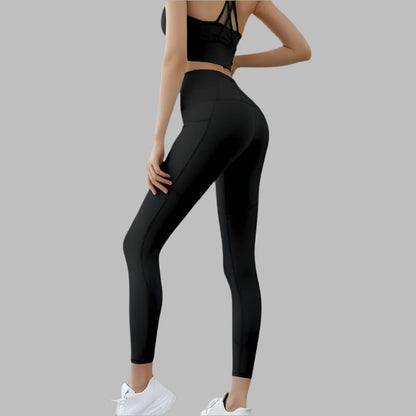 Black high waist pocket leggings shown from the side, paired with athletic top and white sneakers, highlighting fit and style.