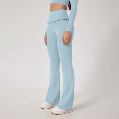 Woman wearing high waist blue leggings and matching top with white sneakers.