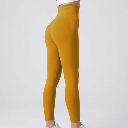 High-waisted golden yellow workout running leggings, available in sizes S, M, L, shown on a model's side profile.