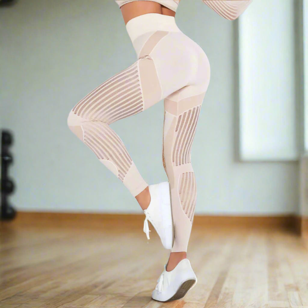 Beige hip-lifting sports leggings with mesh panels for enhanced style and comfort, shown on a model. Available in sizes XS-L.