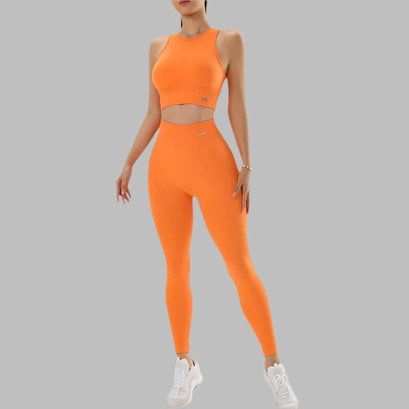 Bright orange 2-piece activewear set featuring a sleeveless crop top and high-waist leggings, ideal for workouts, with white sneakers.