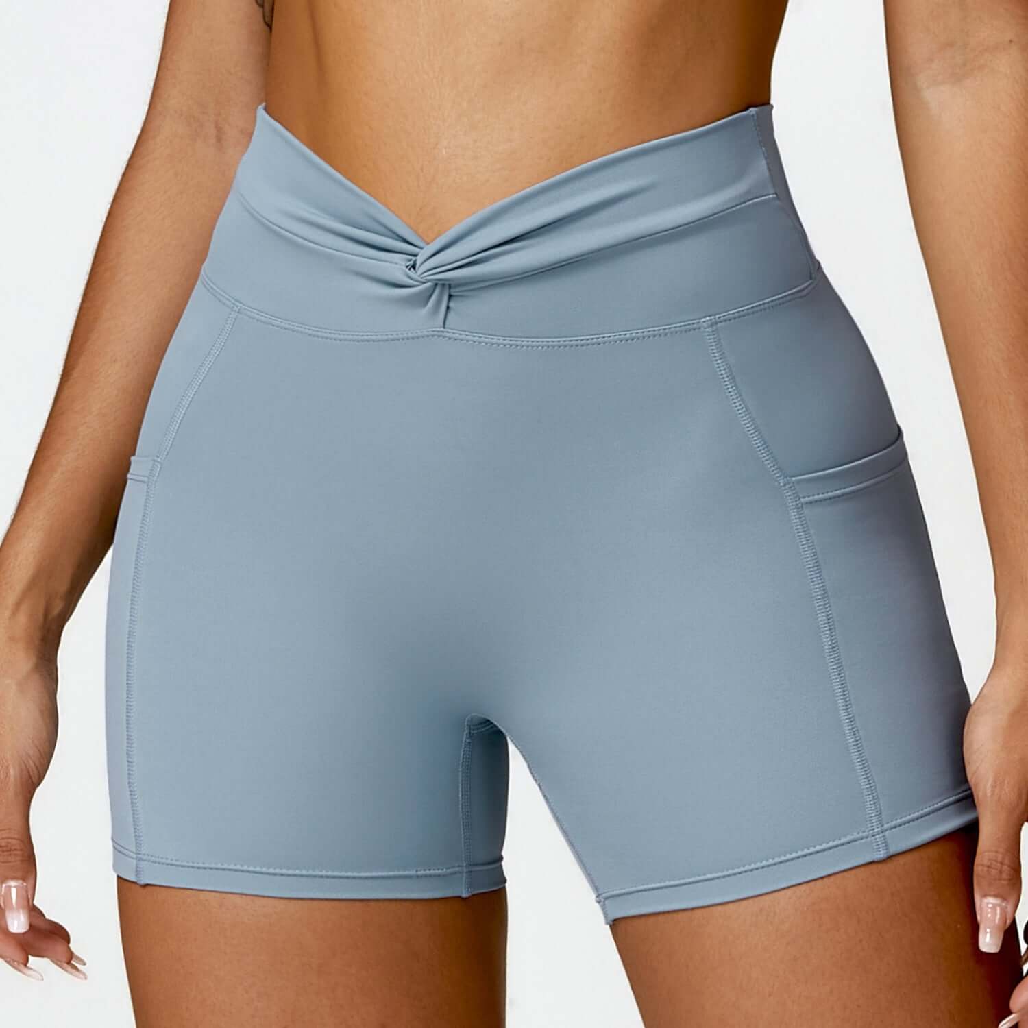Women's high-waisted outdoor running shorts in light blue with side pockets, perfect for exercise and fitness.