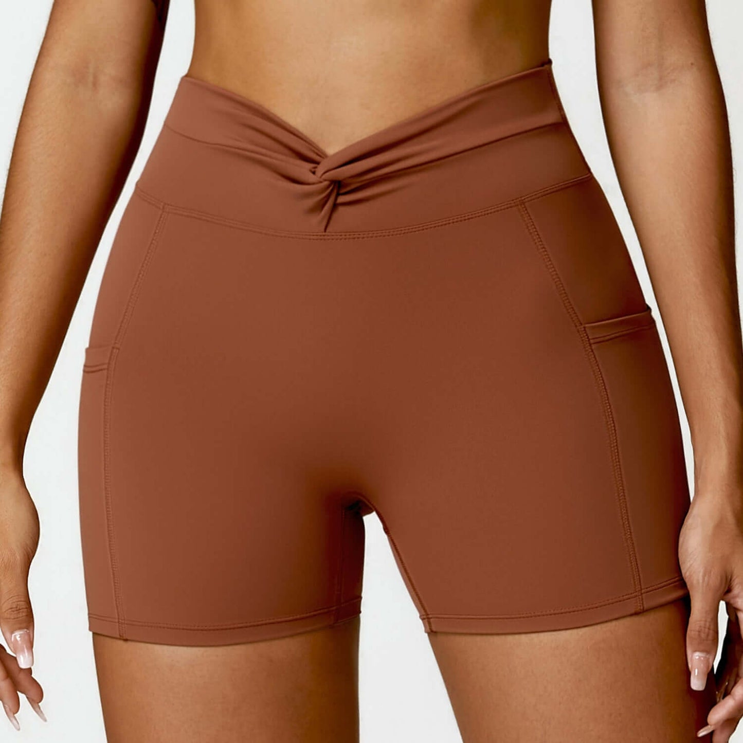 High-waisted outdoor running shorts in brown with side pockets for active wear.