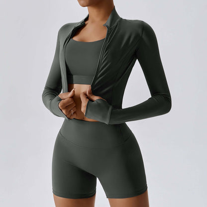 Woman wearing a stylish green outdoor skinny suit with a long-sleeve jacket and high-waisted shorts set. Perfect for active lifestyle.