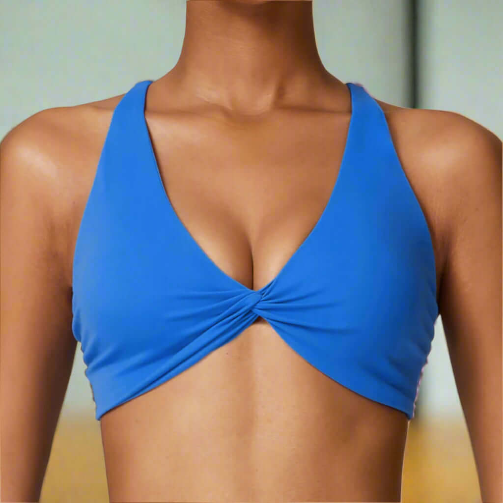 Blue quick-dry sports bra with a sculpted fit and cross-back straps, ideal for running, yoga, and gym workouts in breathable fabric.