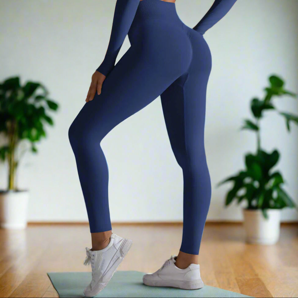 Woman wearing seamless high waist leggings in blue with white sneakers, showcasing a stylish and comfortable fitness outfit.