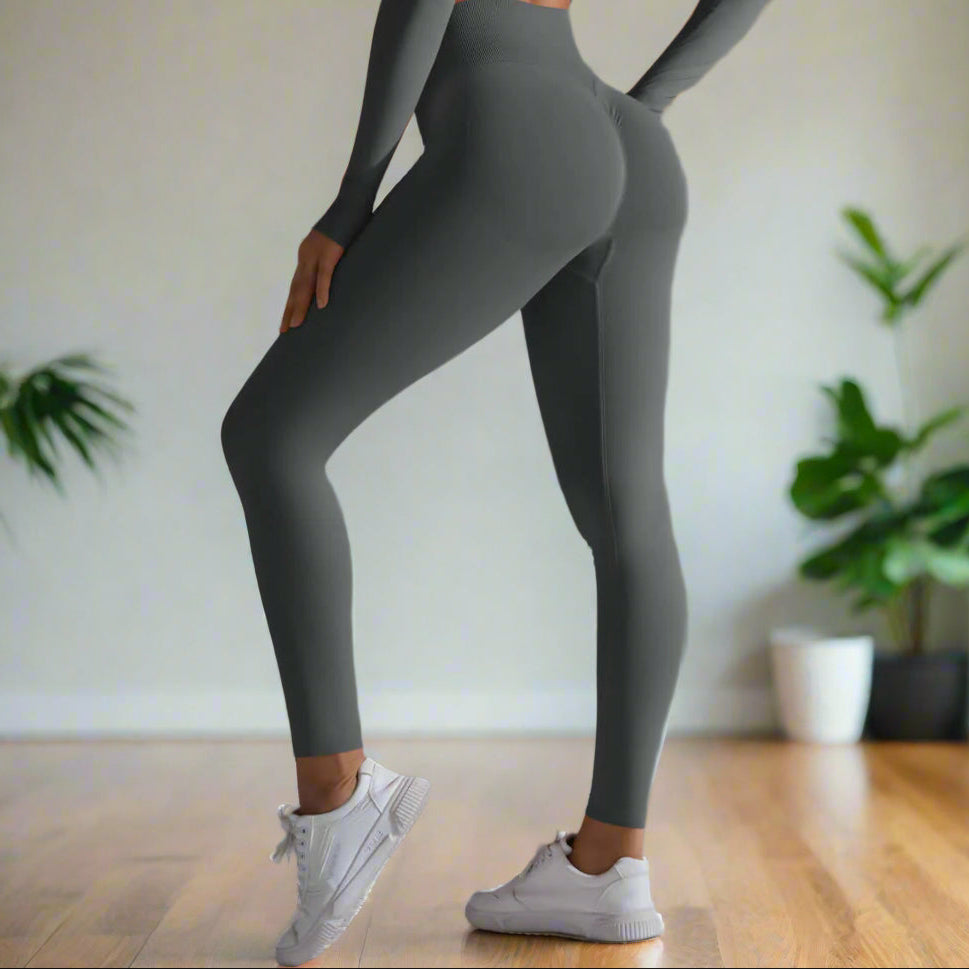 Alt Tag: Seamless high waist leggings in grey, designed for comfort and style, shown with a matching top and sneakers for a sporty look.