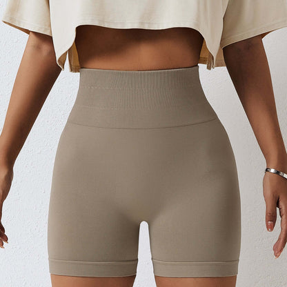 Model wearing beige seamless high-waist shorts showcasing comfortable fit and smooth fabric.