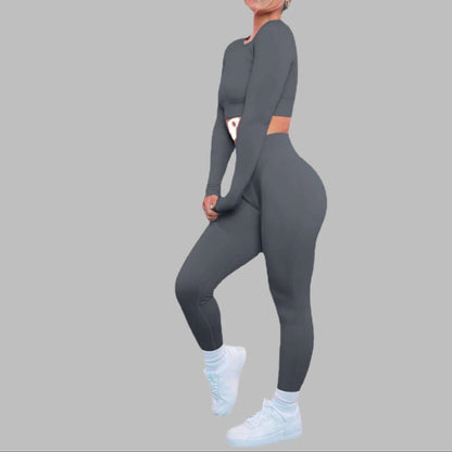 Woman modeling seamless knitted striped suit with sneakers, showcasing comfortable fit and style.