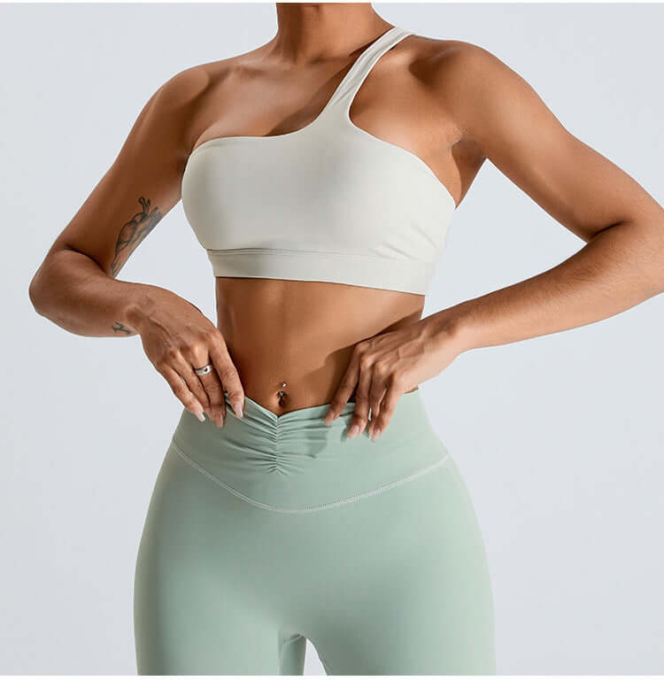 Women's fashion yoga set with one-shoulder top and high-waisted leggings in a stylish activewear design.