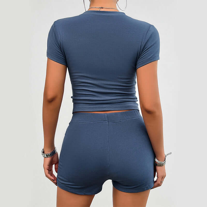 Back view of Slim Sport Set in Gray Blue featuring a fitted crop top and high-waisted shorts for stylish active wear.