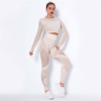 Woman wearing a stylish beige striped fitness set with long sleeves and leggings, posing confidently in athletic shoes.