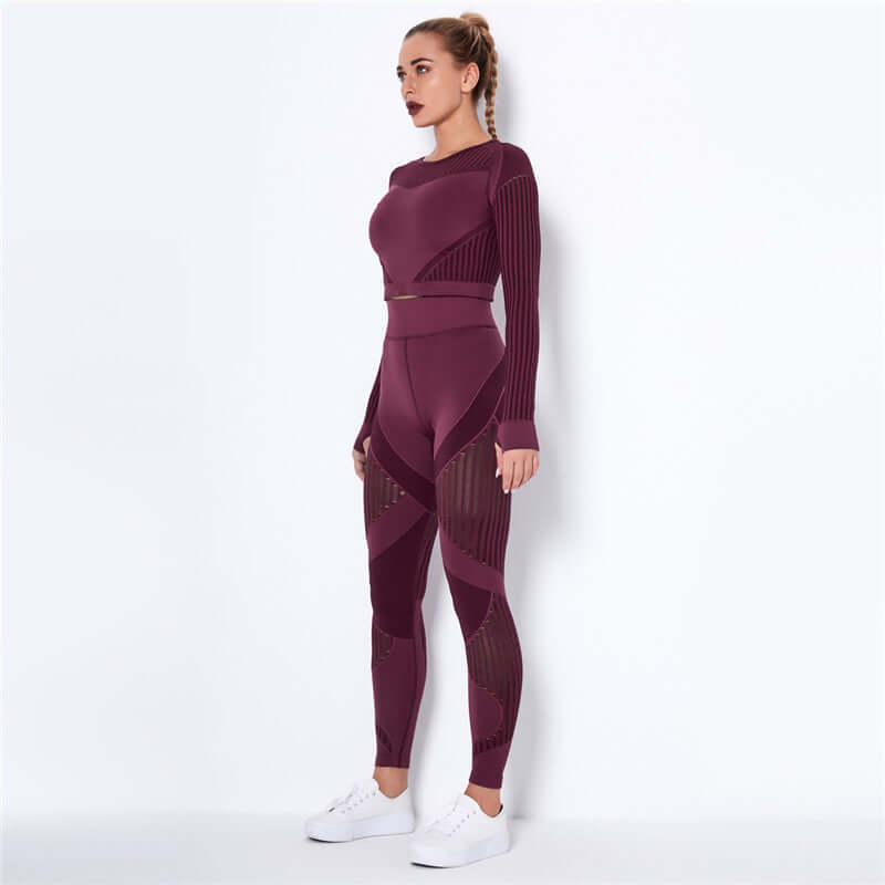 Woman wearing a burgundy striped fitness set with long sleeves and leggings, standing against a white background.