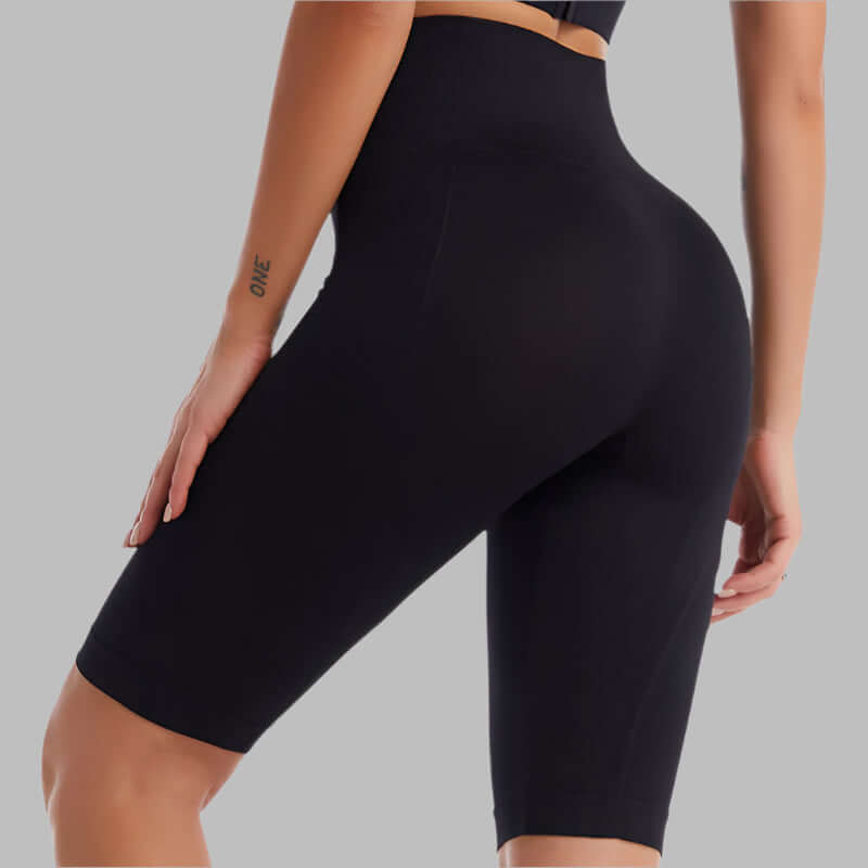 Woman wearing black seamless tight fit training leggings, showcasing stretchy and comfortable activewear ideal for yoga and gym workouts.