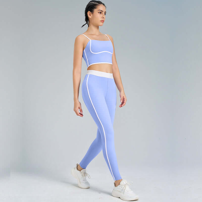 Woman wearing ultra-soft yoga outfit, 2-piece set in light blue, consisting of crop top and leggings, perfect for fitness and yoga.